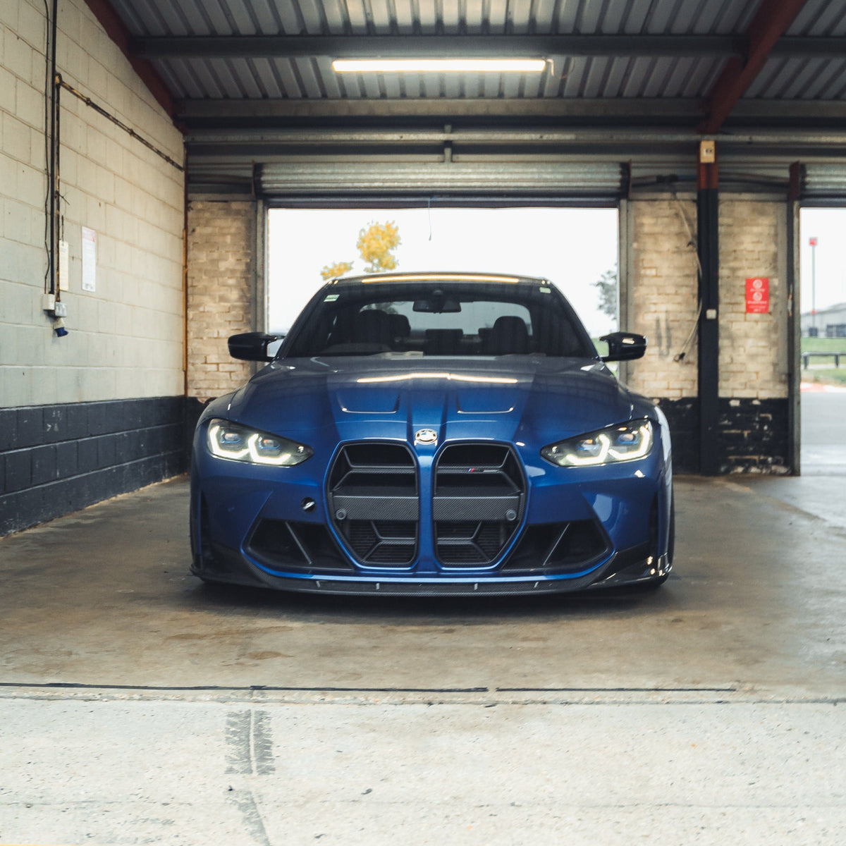 BMW M3 M4 G80 G82 G83 carbon fibre grille by CT Carbon, showing sleek black mesh design without accessories.