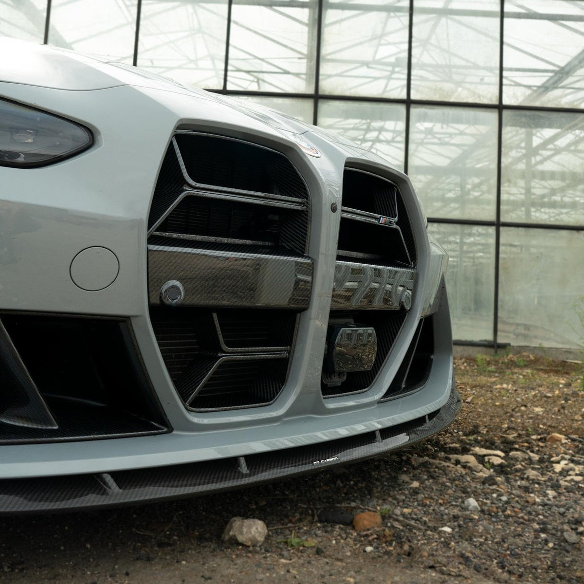 BMW M3/M4 G80/G82 carbon fiber splitter by CT Carbon, showing sleek aerodynamic design with detailed carbon fiber finish.