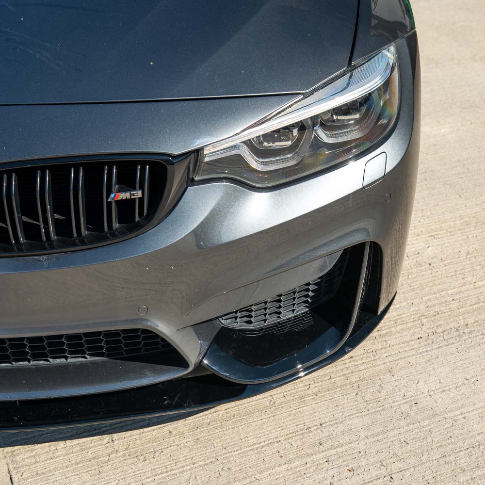 BMW M4 F82 coupe full gloss black kit by CT Carbon, featuring sleek exterior modifications and black finish details.