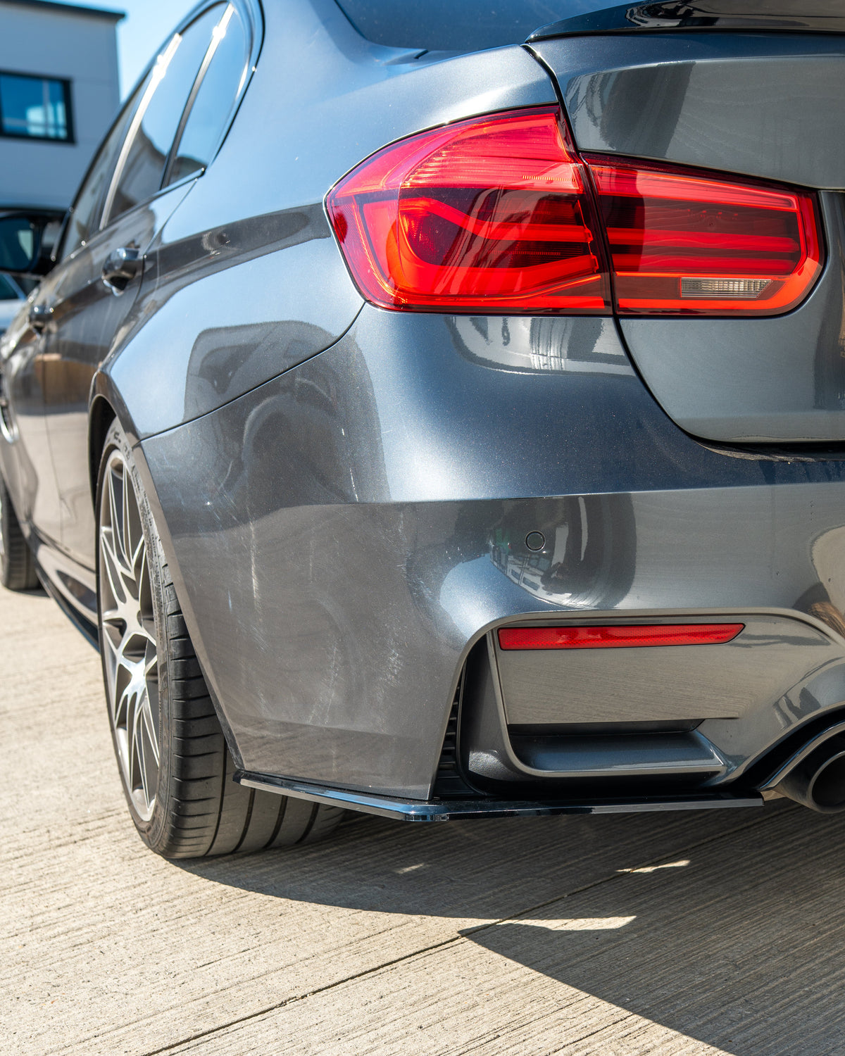 BMW M3 M4 F80 F82 F83 GLOSS BLACK V STYLE diffuser by CT Carbon, showcasing the sleek, aerodynamic rear diffuser on a coupe.