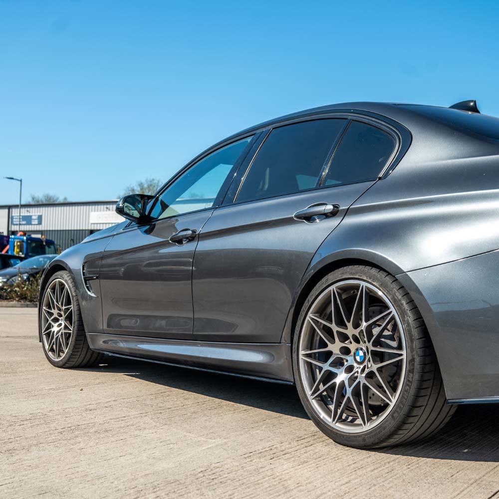 BMW M3/M4 F80/F82/F83 GLOSS BLACK Side Skirts by CT Carbon installed on a coupe, showcasing sleek, aerodynamic design.