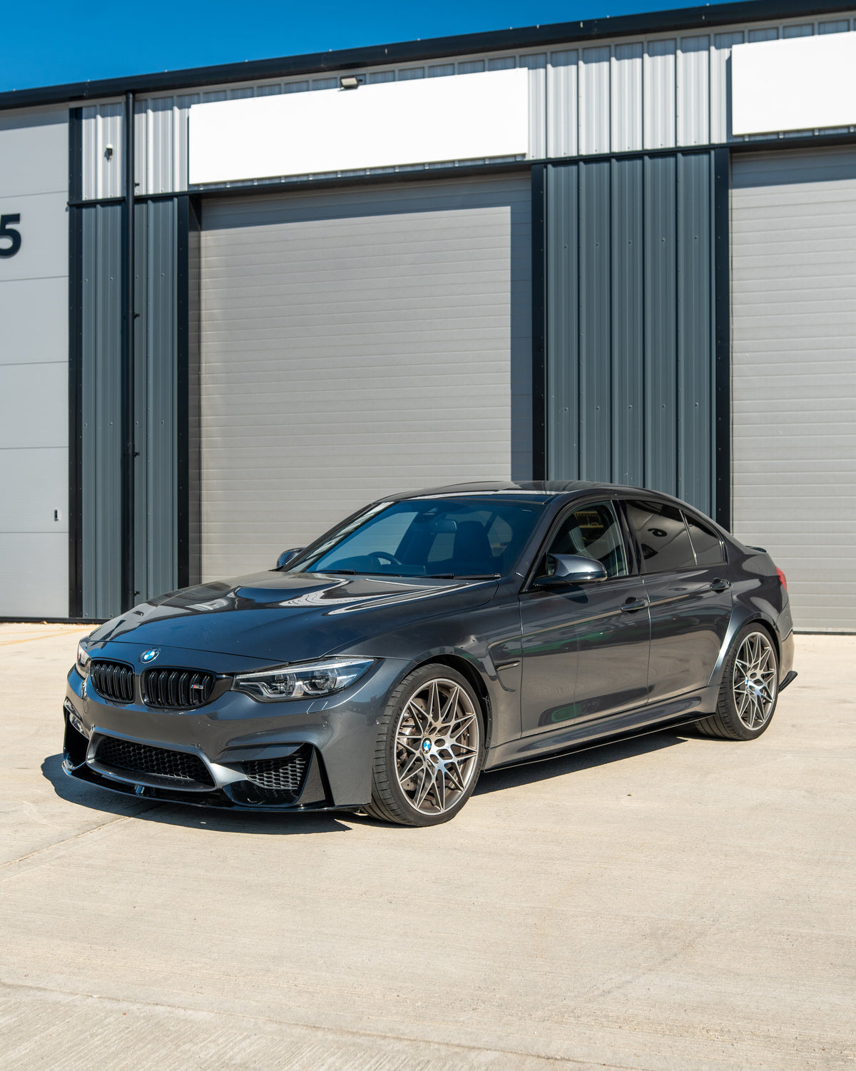 BMW M3 M4 F80 F82 F83 GLOSS BLACK splitter by CT Carbon, shown on a coupe with sleek, aerodynamic design and high-gloss finish.