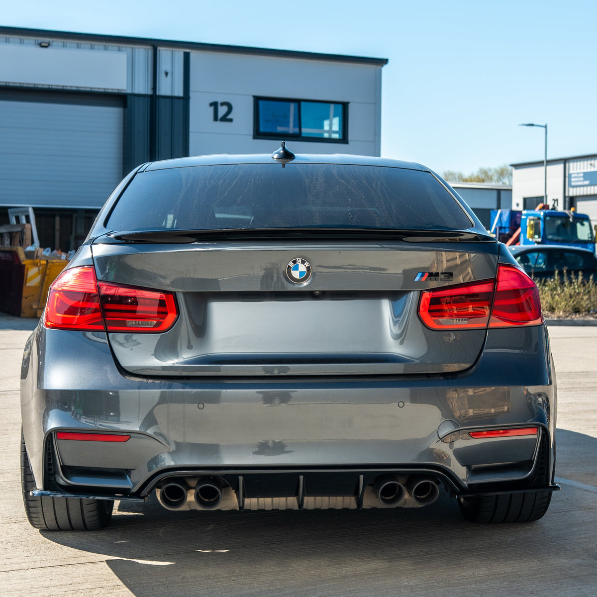 BMW 3 Series F30 GLOSS BLACK spoiler by CT Carbon installed on a coupe, showcasing a sleek, aerodynamic design in full gloss black finish.
