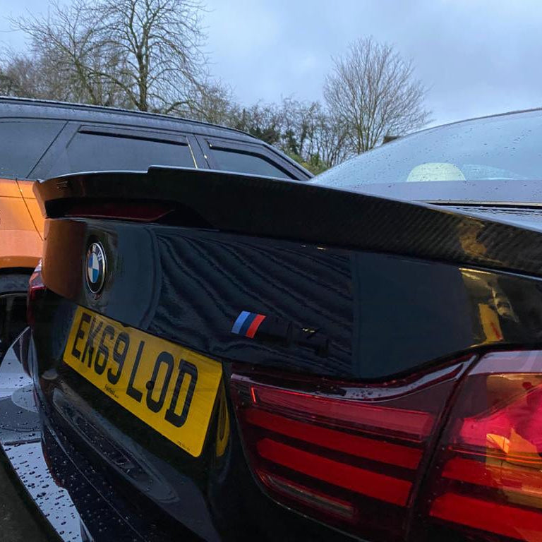 BMW M4 F83 and F33 4 Series carbon fibre spoiler by CT Carbon, V1 style, showing sleek aerodynamic design on a sports car.