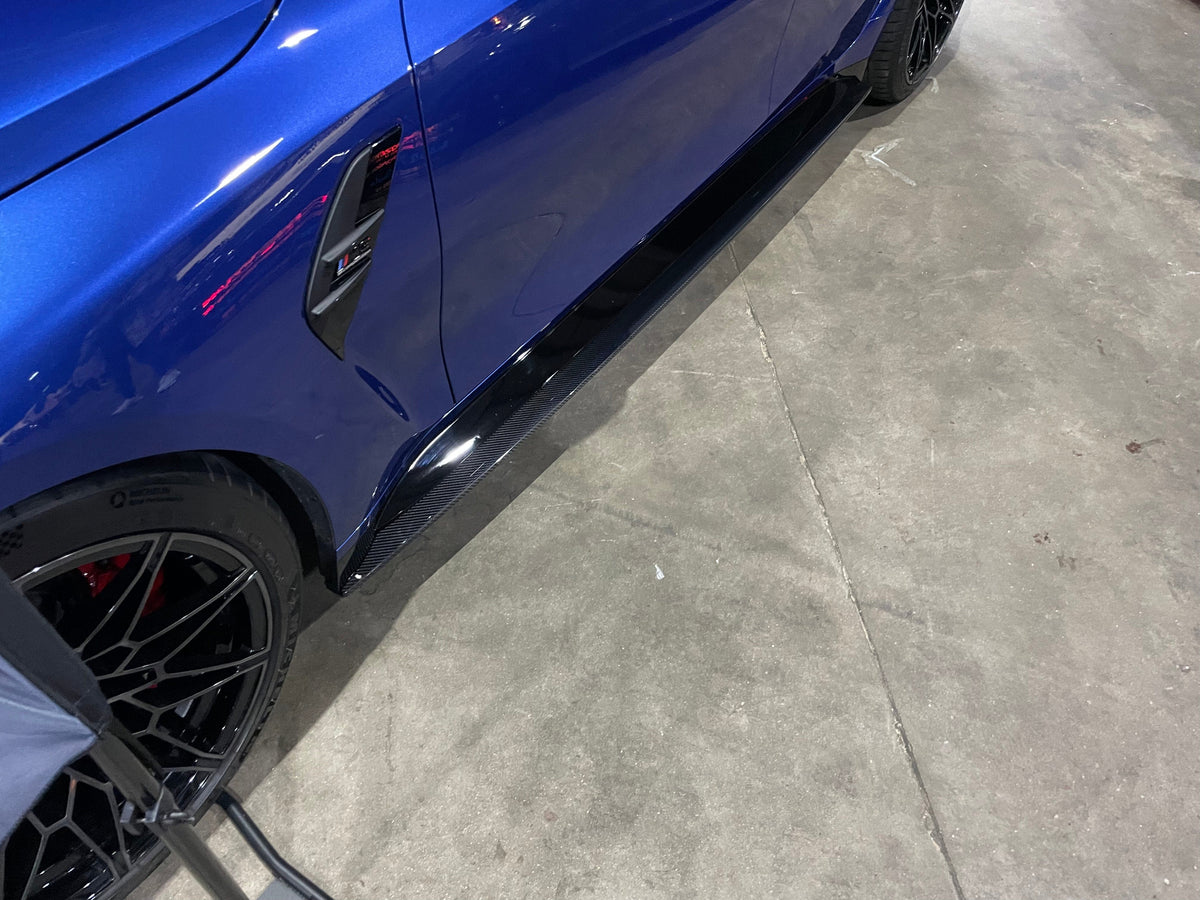 BMW M4 G82 G83 carbon fibre side skirt extensions by CT Carbon, showcasing sleek, aerodynamic design on the vehicle's side.