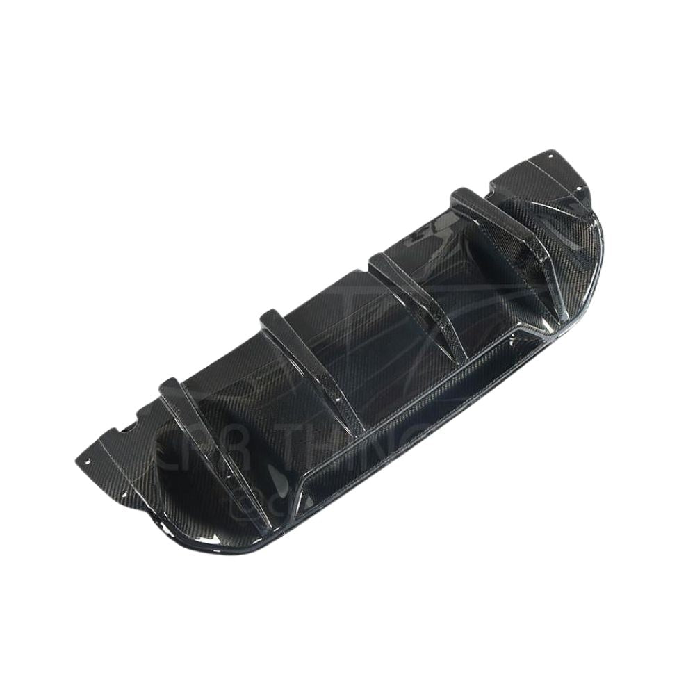 BMW M5 F90 carbon fiber diffuser by CT Carbon, V1 style, showing sleek black carbon fiber surface and aerodynamic design.