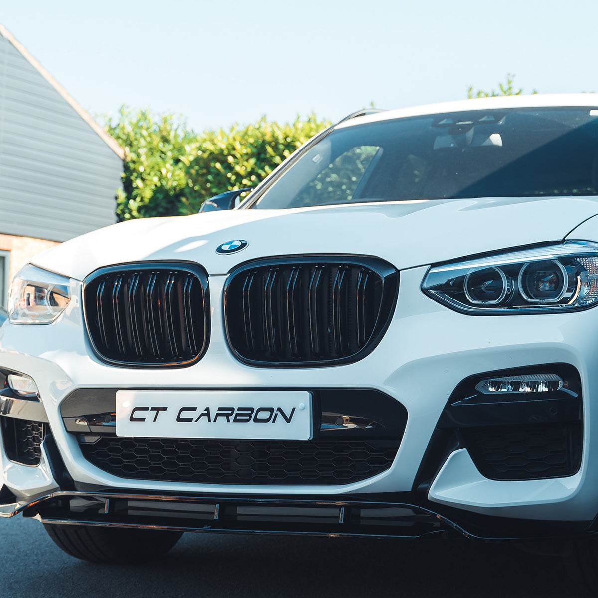 BMW X3 G01 2017-2020 full gloss black kit with exhaust tips by CT Carbon, featuring car body parts with a sleek black finish.