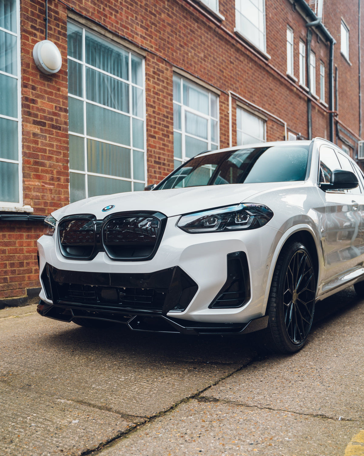 BMW X3 G01 and iX3 G08 LCI 2022-2024 CT Carbon gloss black splitter installed on front bumper, enhancing sporty look.