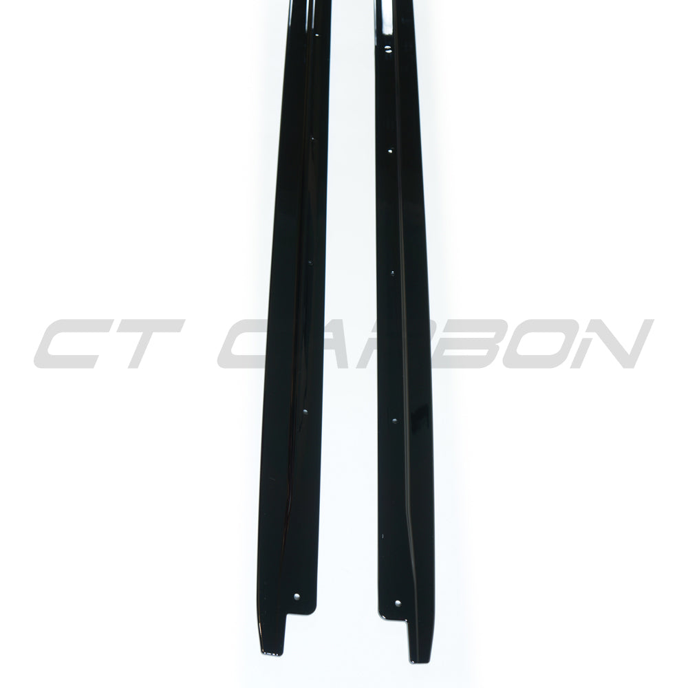 BMW X5 2014-2018 F15 CT Carbon gloss black full-length side skirts installed on vehicle, enhancing sporty appearance.