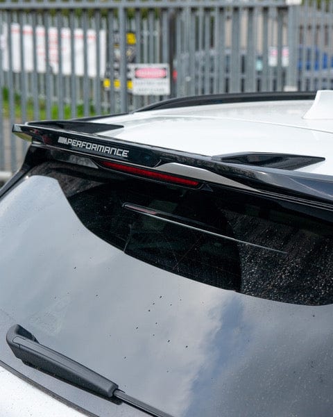 BMW X5 G05 2018+ CT Carbon gloss black spoiler installed on the rear of the vehicle, showcasing a sleek aerodynamic design.