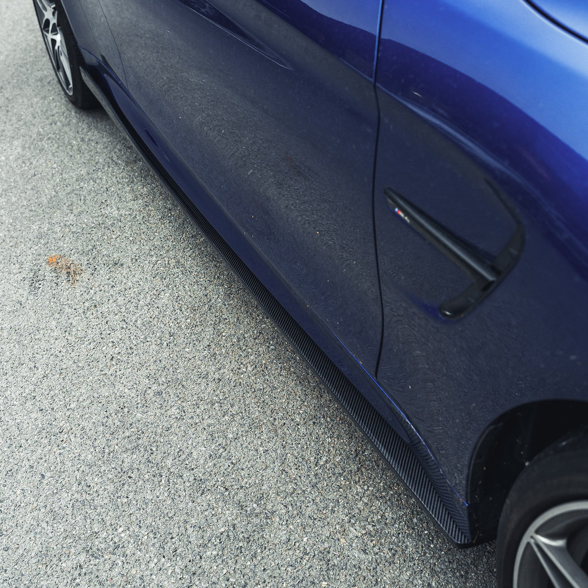BMW M3 M4 F80 F82 carbon fibre side skirts by CT Carbon, showing sleek, aerodynamic design for sporty exterior enhancement.