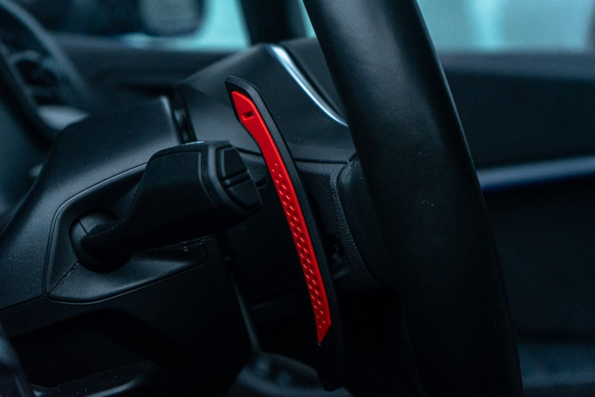 BMW and MINI Fxx Gxx carbon fiber shifter paddles by CT Carbon, shown in close-up with textured black finish.