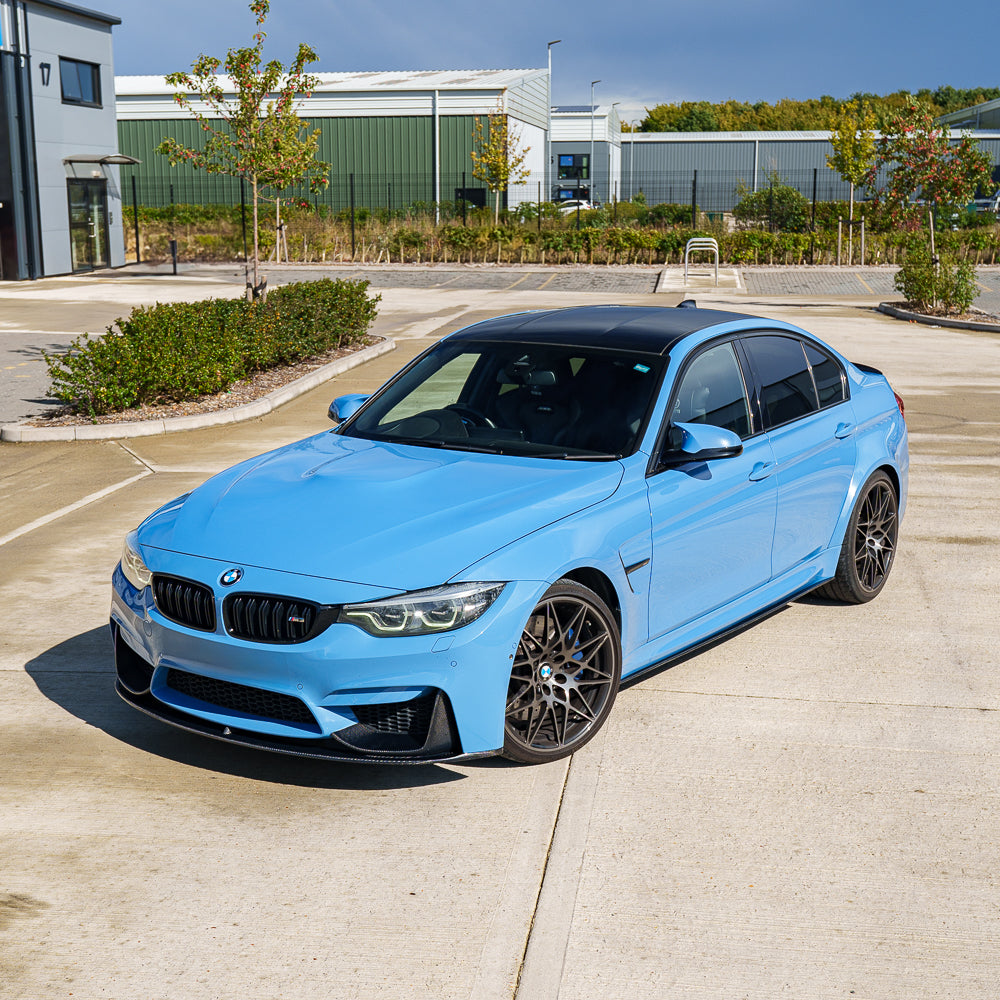 Blue BMW M3 F80 full carbon fiber kit by CT Carbon, showing detailed close-up of the lightweight carbon fiber components.