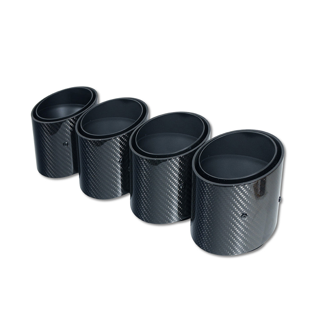 Set of four black carbon exhaust tips for BMW M2 M3 M4 G87 G80 G81 G82 G83 by CT Carbon, with slash cut design.
