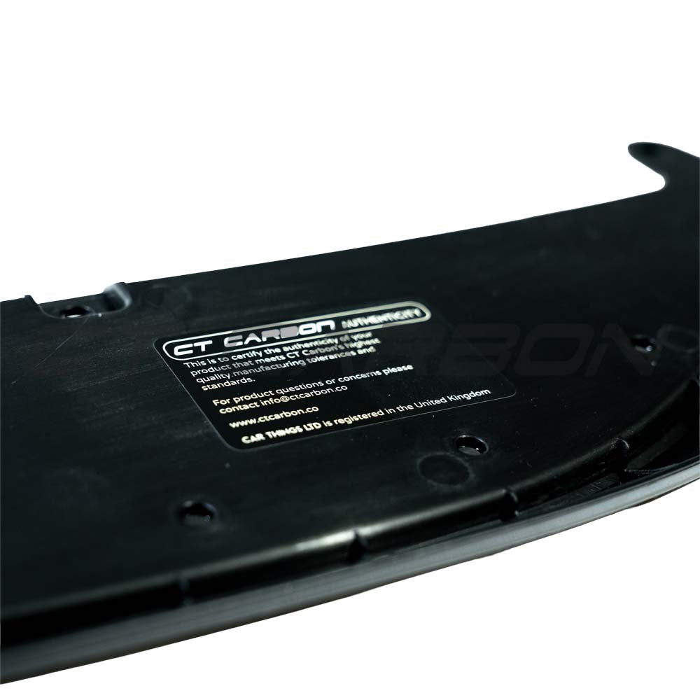 Gloss black BMW M3 M4 F80 F82 F83 splitter by CT Carbon, showing the aerodynamic front bumper accessory with detailed finish