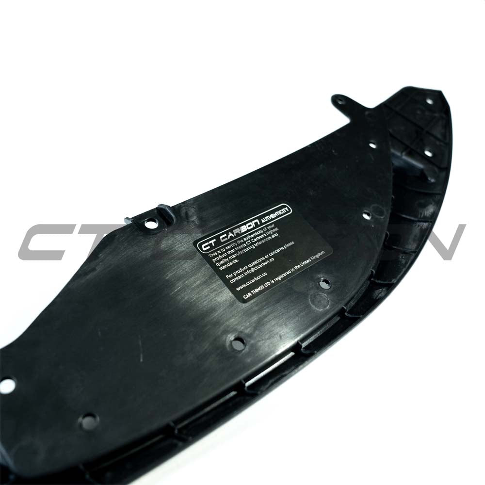 Gloss black splitter for BMW M3/M4 F80 F82 F83 (2014-2020) by CT Carbon, showcasing aerodynamic car part on a vehicle.
