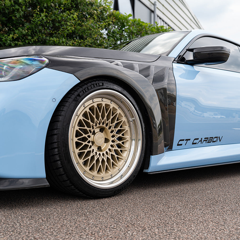 BMW G87 M2 CT Design full carbon fibre kit, including body panels and accessories, showcasing sleek, lightweight carbon fibre components.