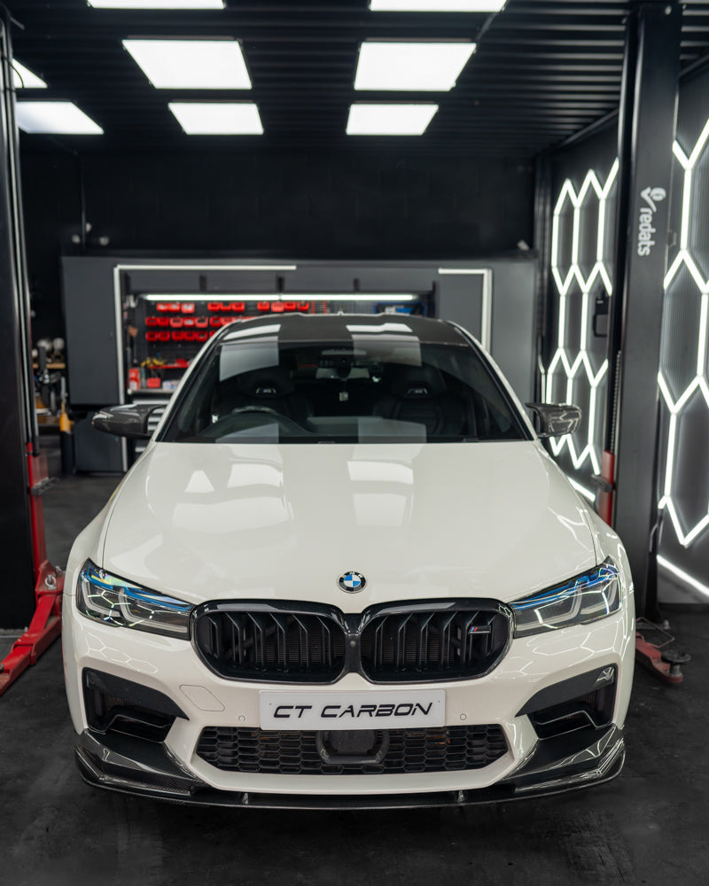 BMW F90 M5 carbon fibre splitter by CT Carbon, showing the sleek V4 design mounted on the front bumper.