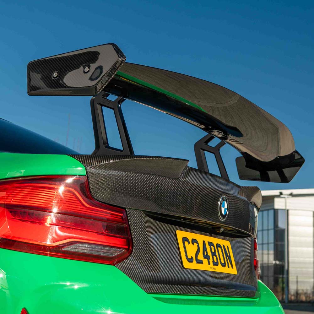 BMW F87 M2 carbon fiber full car kit by CT Carbon, including hood, roof, and trunk components, displayed on a white background.