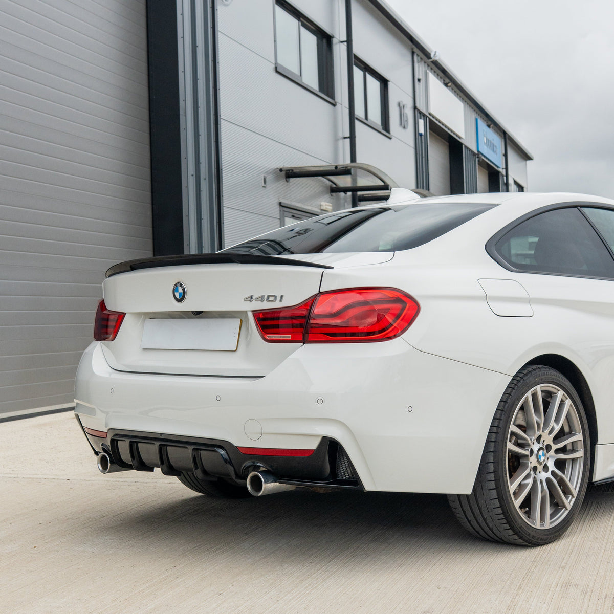 BMW 4 Series F32/F33/F36 CT Carbon gloss black dual exit exhaust diffuser V2, showing sleek aerodynamic design and finish.