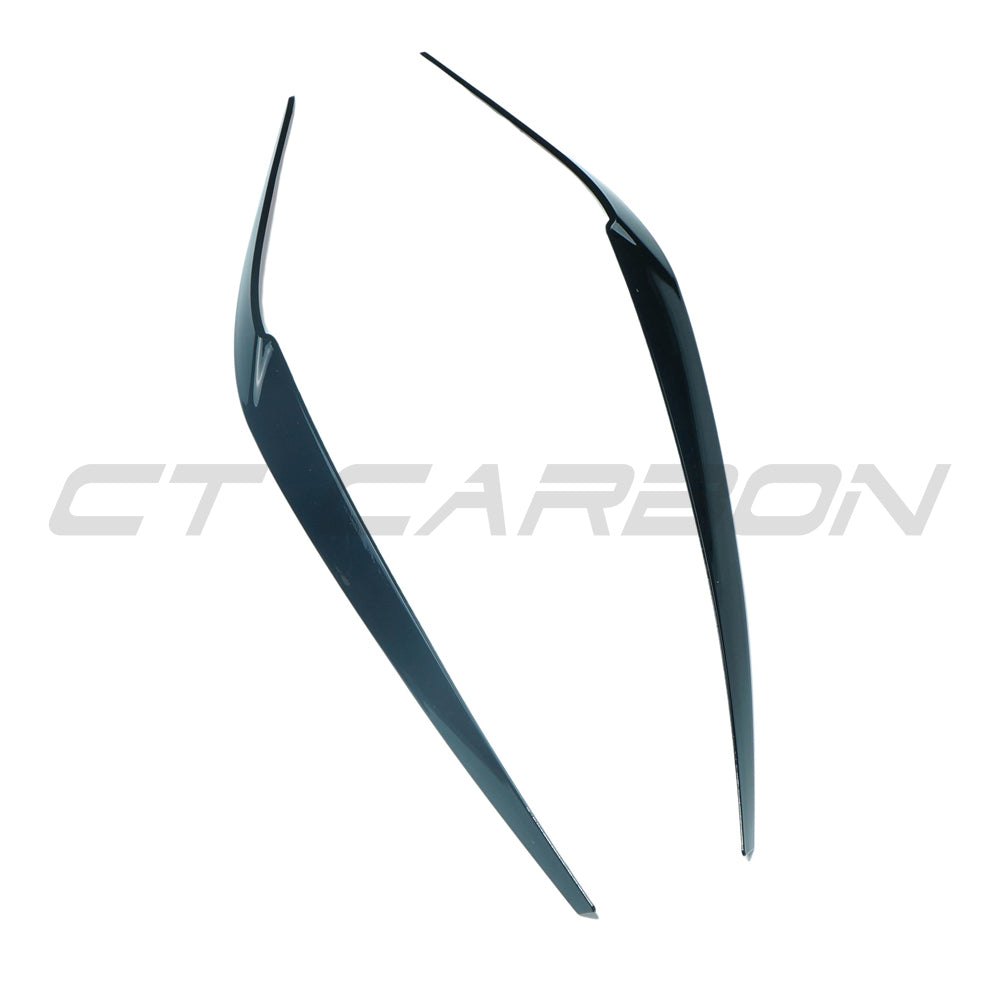 BMW 5 Series G30 gloss black headlight eyebrows accessory by CT Carbon, showing sleek, curved headlight eyelids on a car.