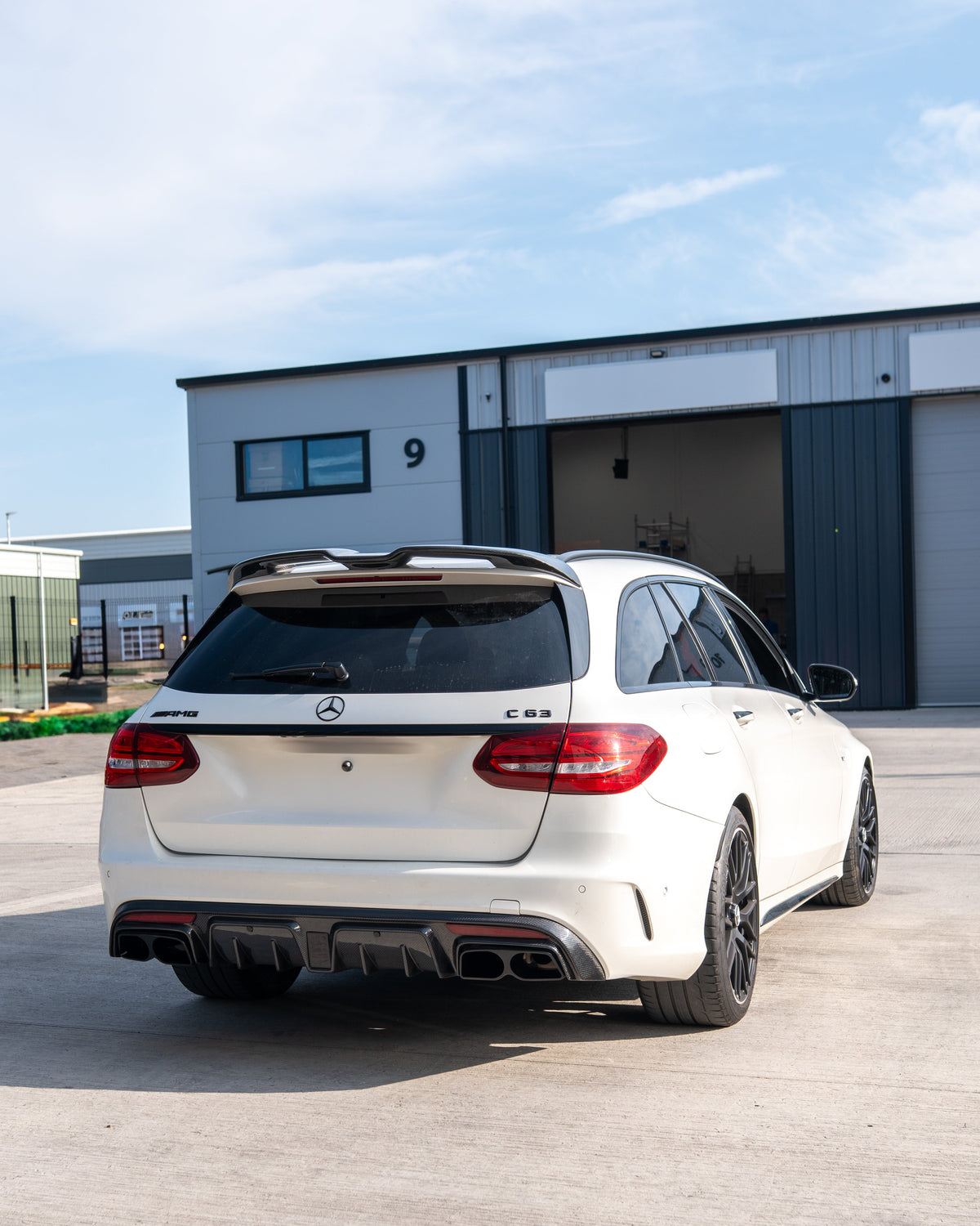 Mercedes W205 C63 and C63S saloon carbon fibre diffuser with exhaust tips by CT Carbon, shown from the rear angle.