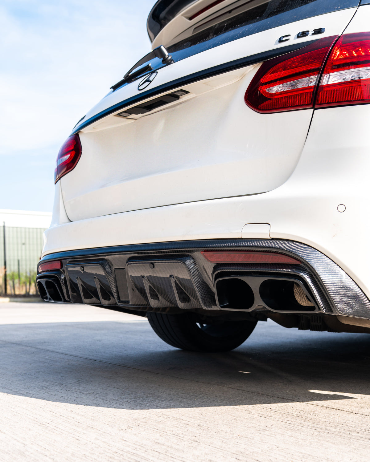 Mercedes W205 C63 and C63S saloon carbon fiber diffuser with exhaust tips, featuring sleek design and high-performance look.