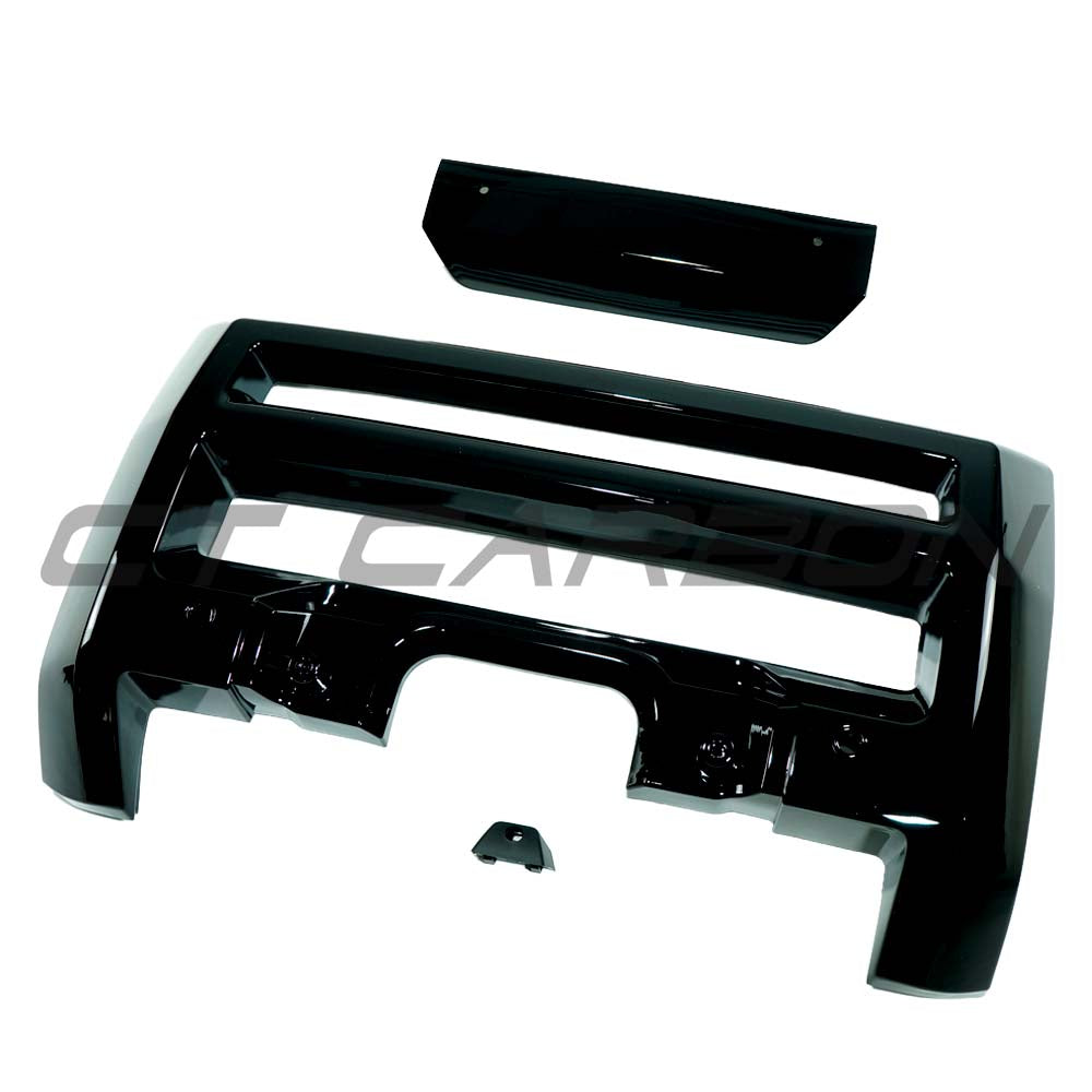 Gloss black front bumper trim for Land Rover Defender L663 2020+ from CT Carbon, shown on the vehicle's front end.