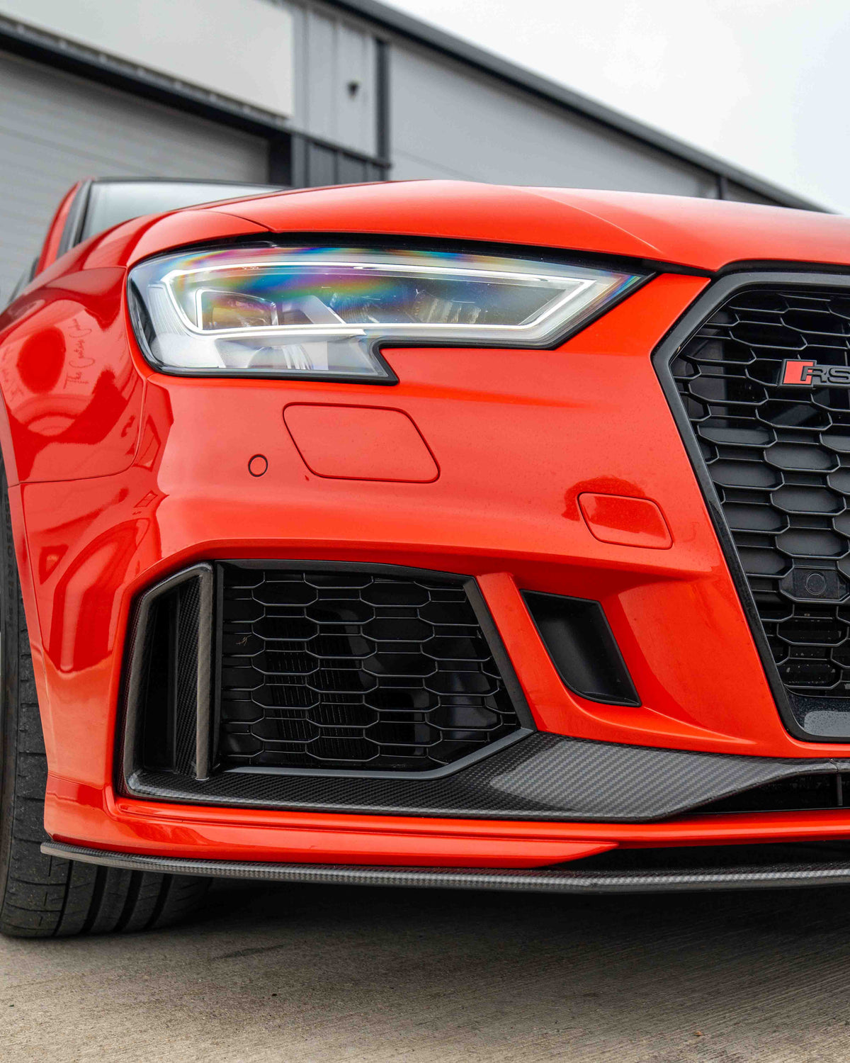 CT Carbon Audi RS3 8V saloon carbon fibre splitter V1, sleek black aerodynamic car accessory on a white background.