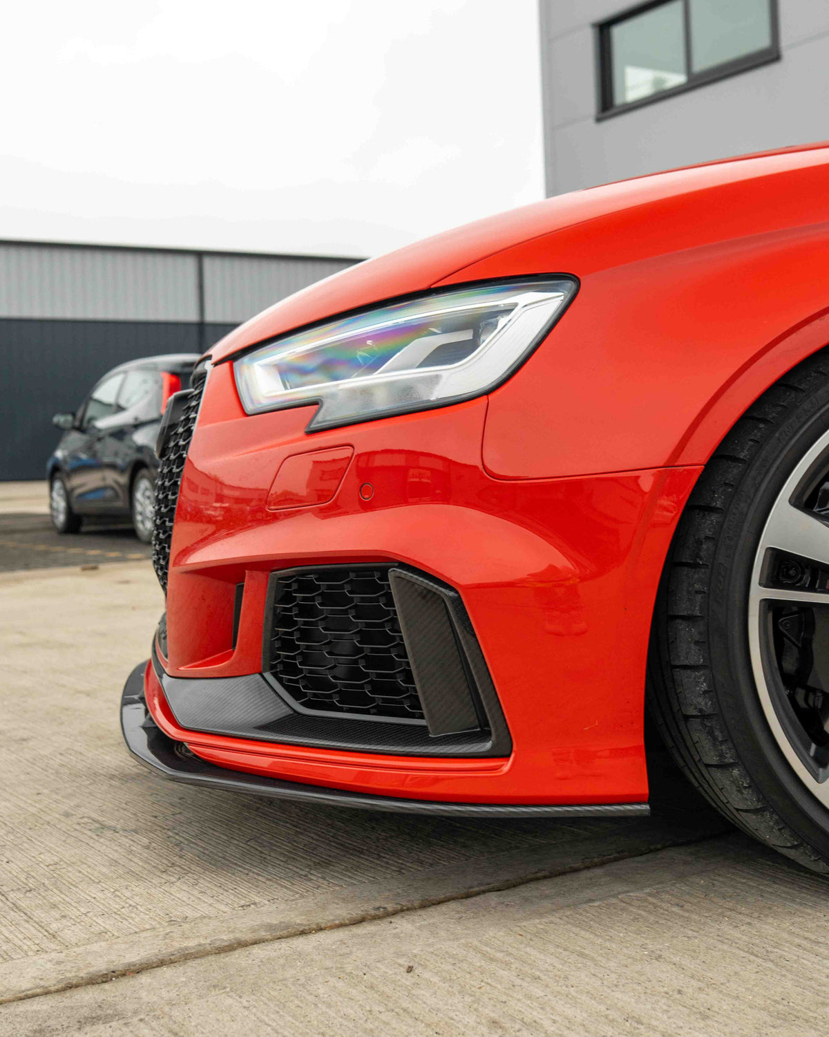 CT Carbon Audi RS3 8V saloon carbon fibre splitter V1 mounted on front bumper, showcasing aerodynamic styling and high-quality craftsmanship.