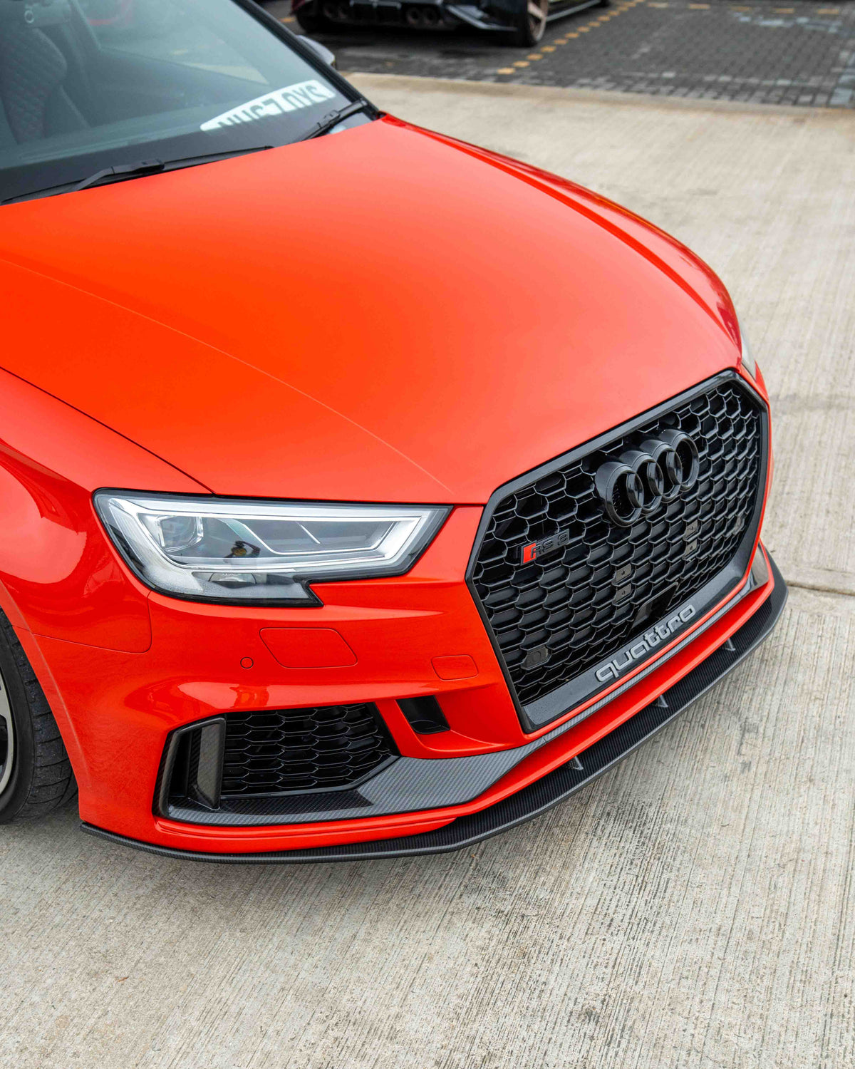 Carbon fibre splitter for Audi RS3 8V saloon by CT Carbon, featuring aerodynamic design and V1 styling.