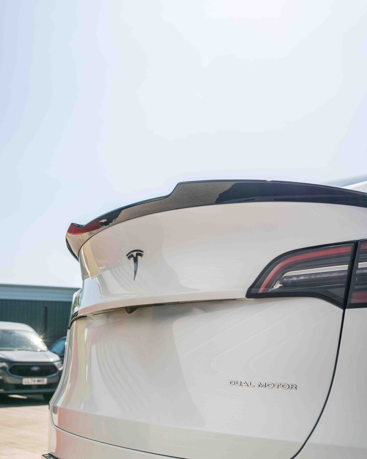 Full gloss black kit for Tesla Model Y MK1 2020-2025 by CT Carbon, featuring detailed close-up of the car's exterior components.