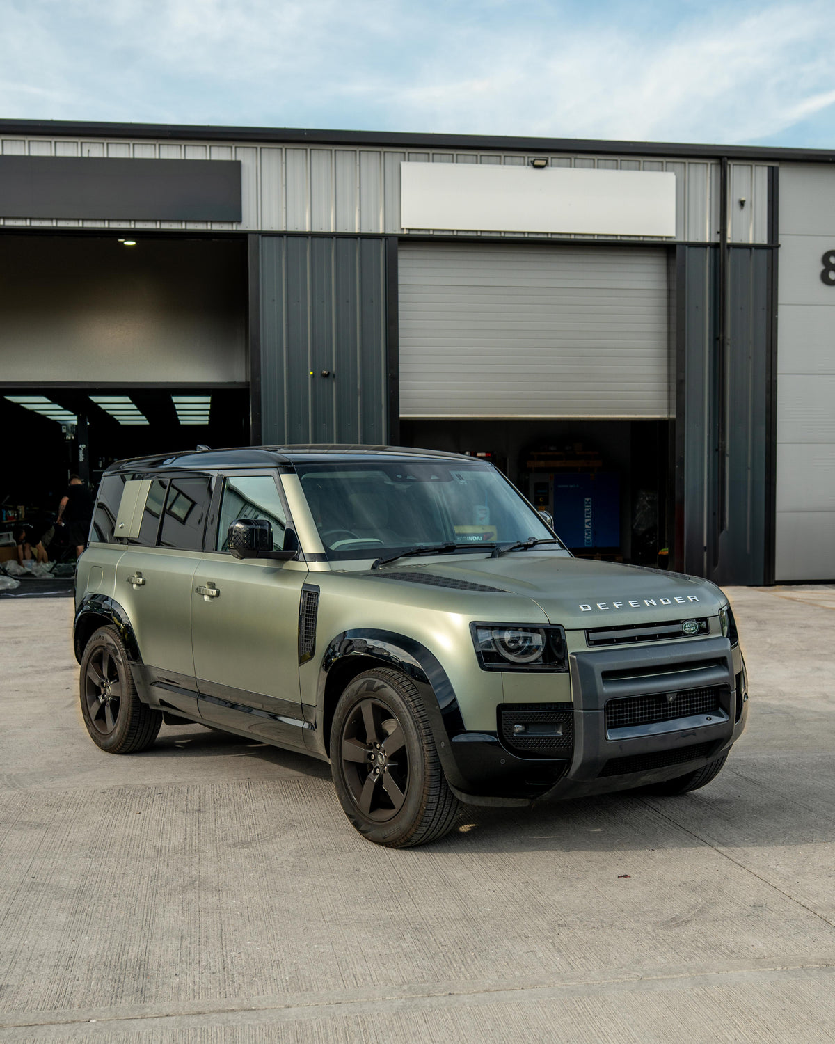 Gloss black door panels for Land Rover Defender L663 110 by CT Carbon, showing sleek, high-quality exterior design details.