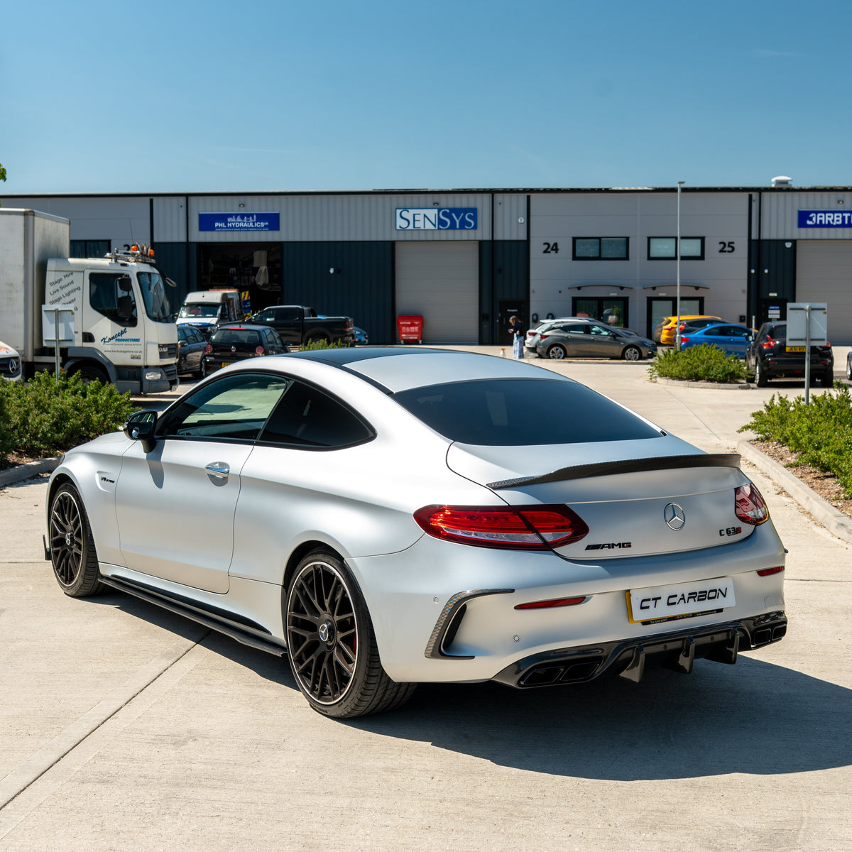 CT Carbon Mercedes C63/C63S W205 coupe carbon spoiler, sleek aerodynamic rear wing, shown on a black vehicle.