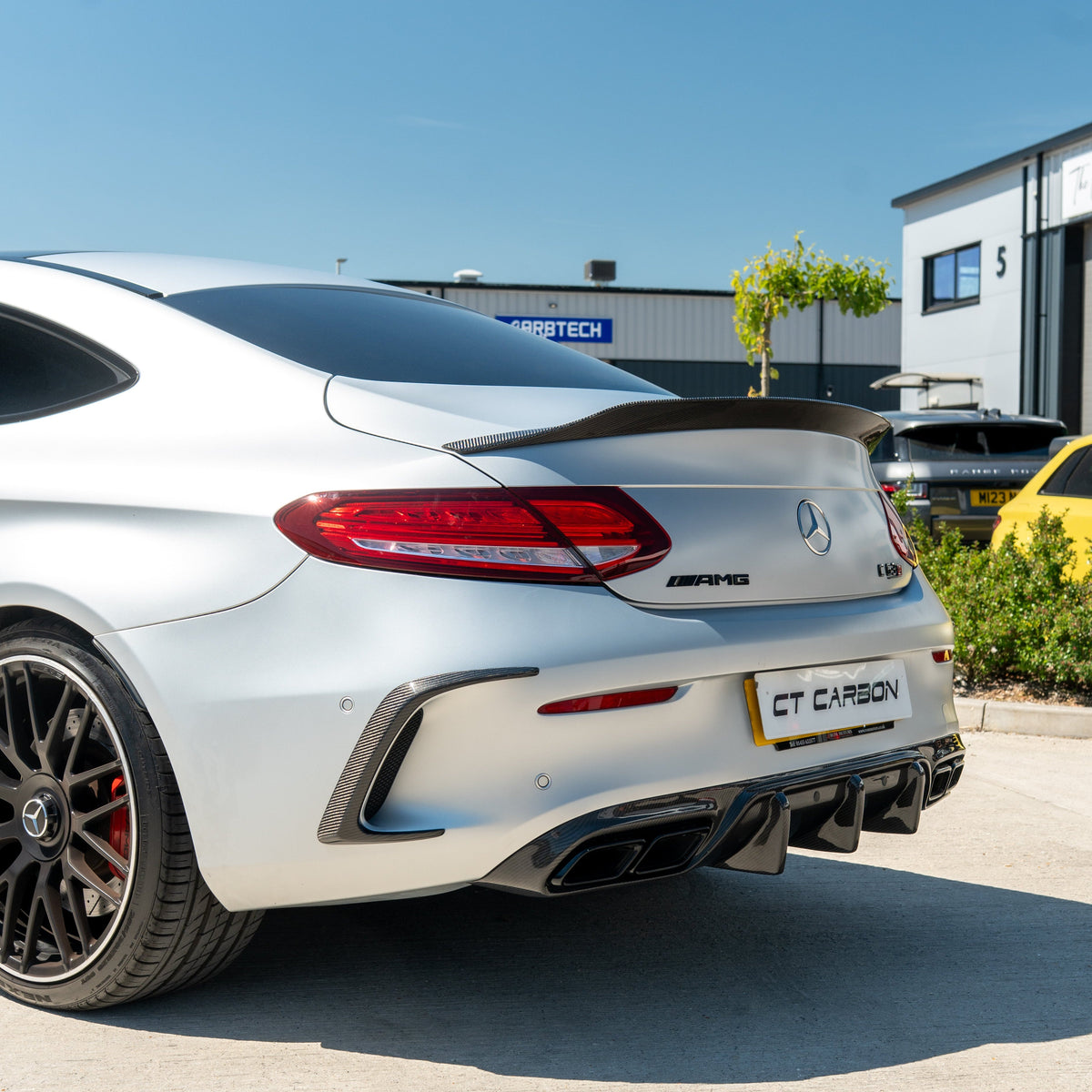 Carbon diffuser for Mercedes W205 C63 Coupe by CT Carbon, showcasing the sleek, aerodynamic design in black finish.