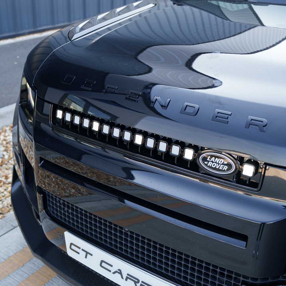 Yellow LED grille for Land Rover Defender L663 2019+ by CT Carbon, showcasing the V3 design on a rugged vehicle.