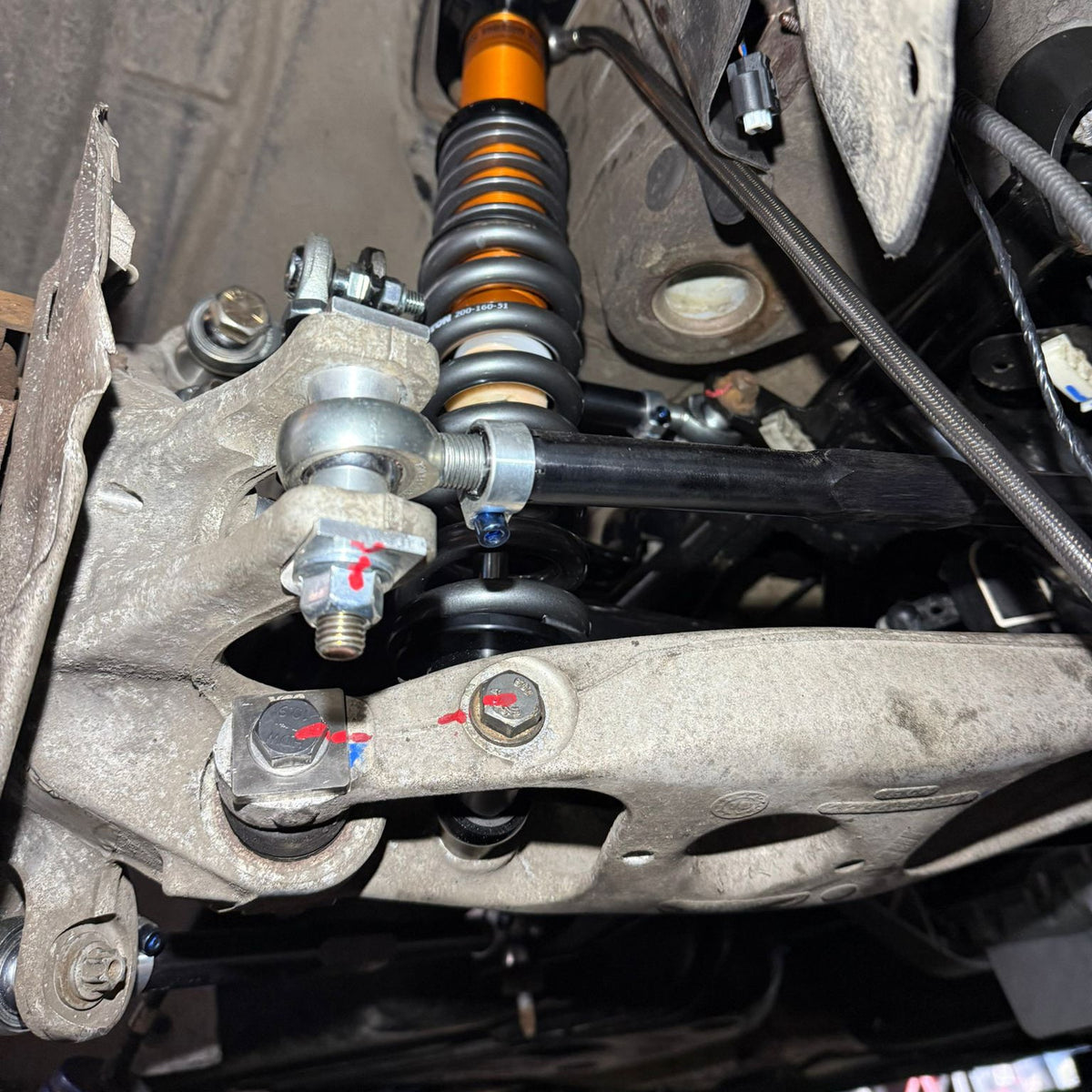 BMW M2, M3, M4 F8X G8X rear camber lockout shims installed on car for suspension and alignment adjustment.