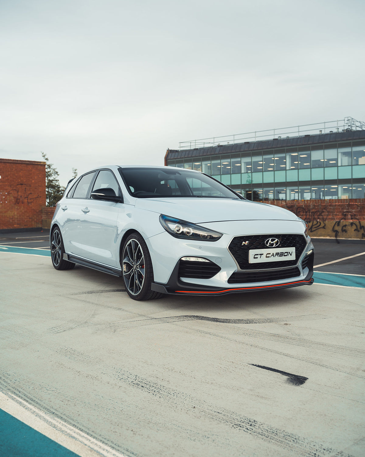 Hyundai i30N carbon fiber kit by CT Design, pre-facelift model, showing close-up of sleek carbon fiber components and finish.