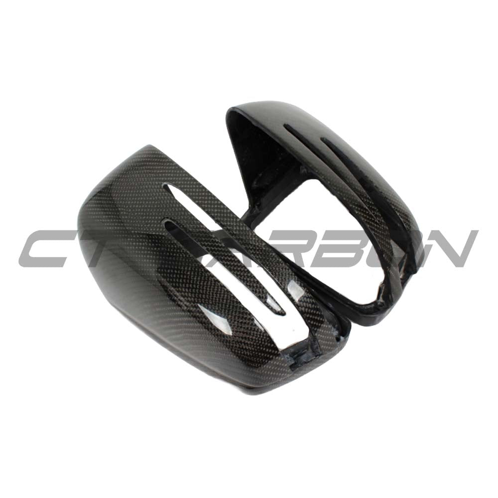 Carbon fiber side mirror covers for Mercedes C and E-Class W204 and W212 by CT Carbon, shown on the vehicle.