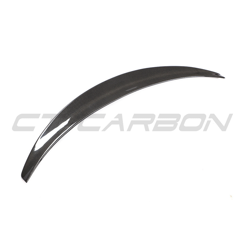 Tesla Model 3 2017-2023 CT Carbon V4 carbon fiber spoiler installed on the rear of the car, showcasing sleek aerodynamic design.