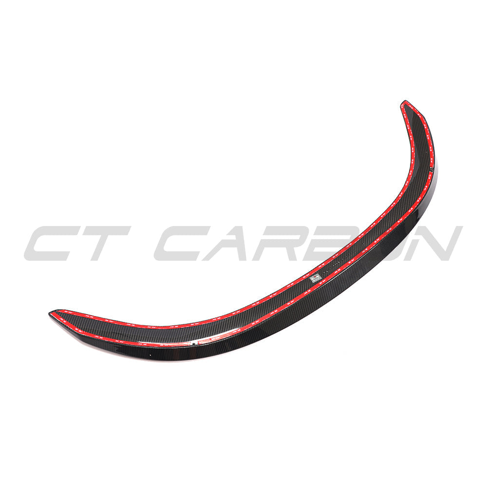 BMW 8 Series and M8 G15/F92 carbon fibre spoiler by CT Carbon installed on the car's rear, showcasing sleek aerodynamic design.