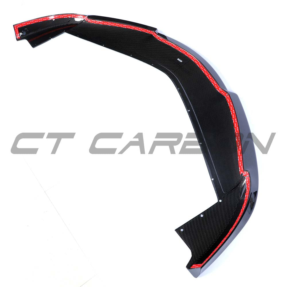 Carbon fiber splitter for McLaren Artura 2023 by CT Carbon, showing detailed close-up of aerodynamic design and textured surface.