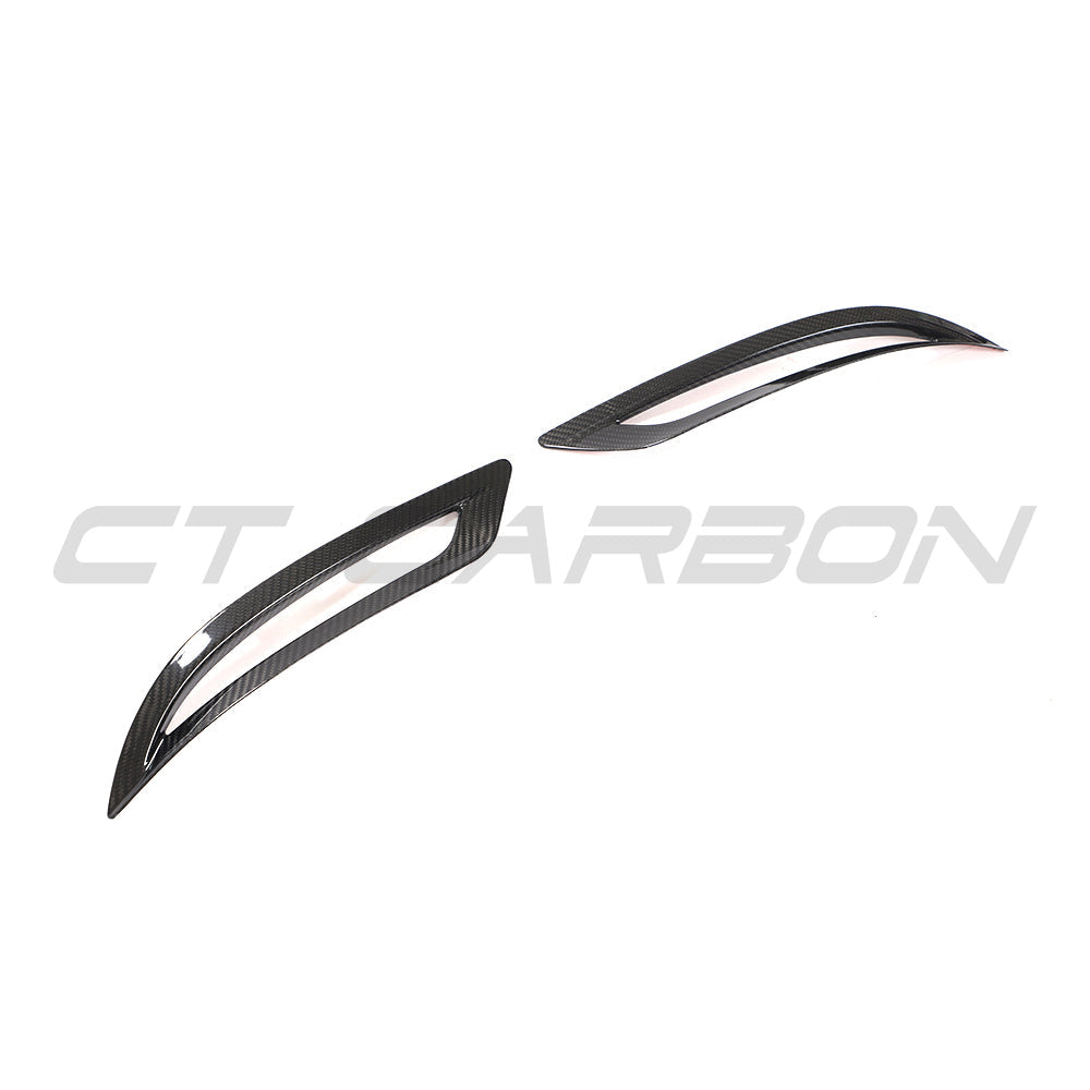 Tesla Model 3 2017-2023 carbon fiber rear reflector cover by CT Carbon, close-up view of sleek black accessory on car's rear.