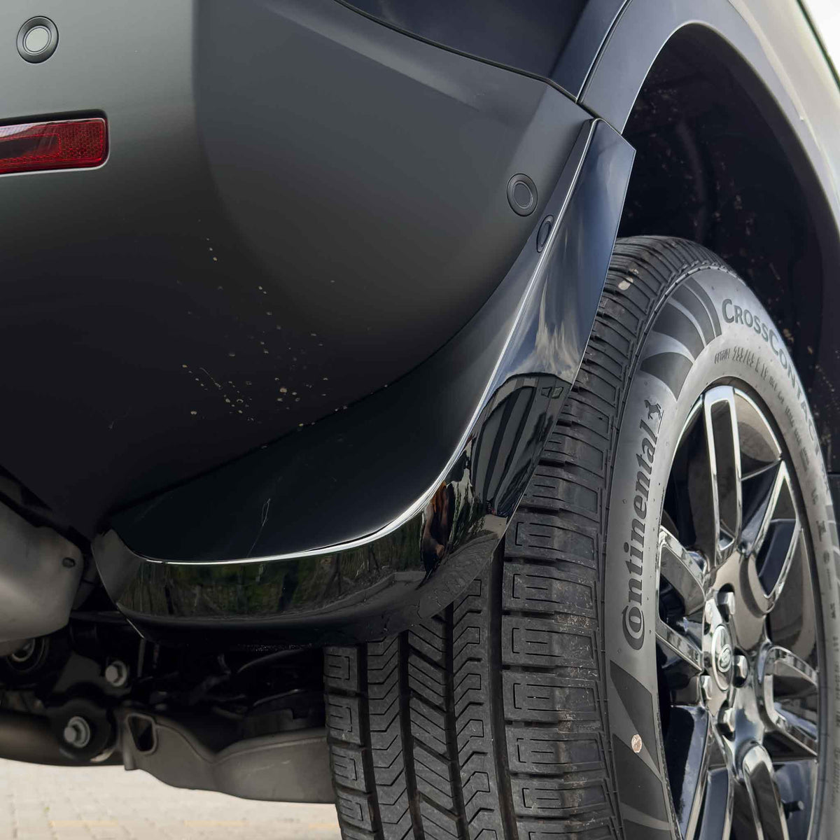 Set of four CT Carbon gloss black mud flaps designed for Land Rover Defender L663 110 and 90 models, accessory vehicle protection.