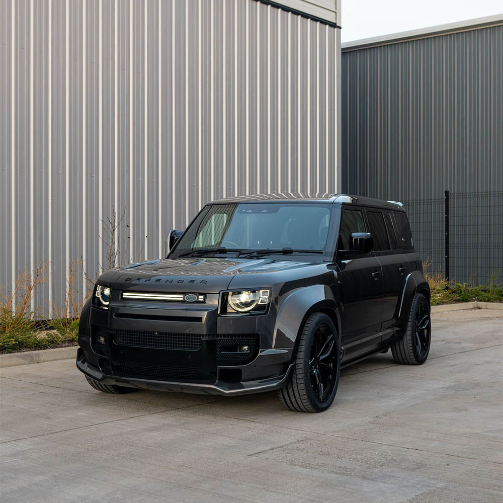 Land Rover Defender L663 110 full carbon fiber wide arch kit by CT Carbon, featuring sleek carbon fiber arches on a rugged SUV.