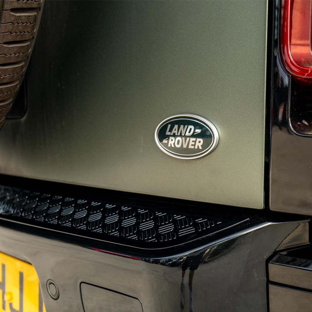 Land Rover Defender L663 110 gloss black anti-scratch trim set by CT Carbon, shown on vehicle, highlighting sleek protective accessories.
