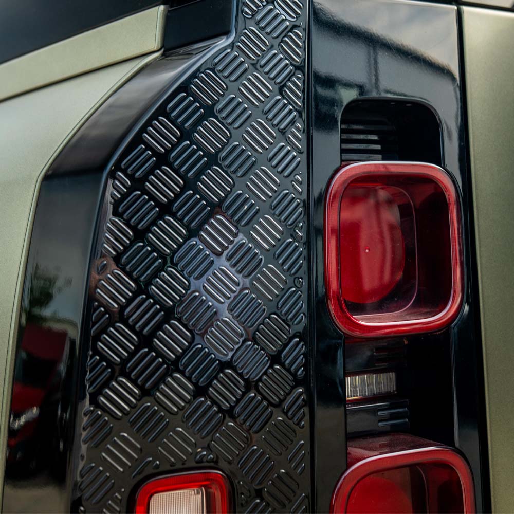 Land Rover Defender L663 110 gloss black anti-scratch trim set by CT Carbon, shown on vehicle with reflective finish and precise fit.