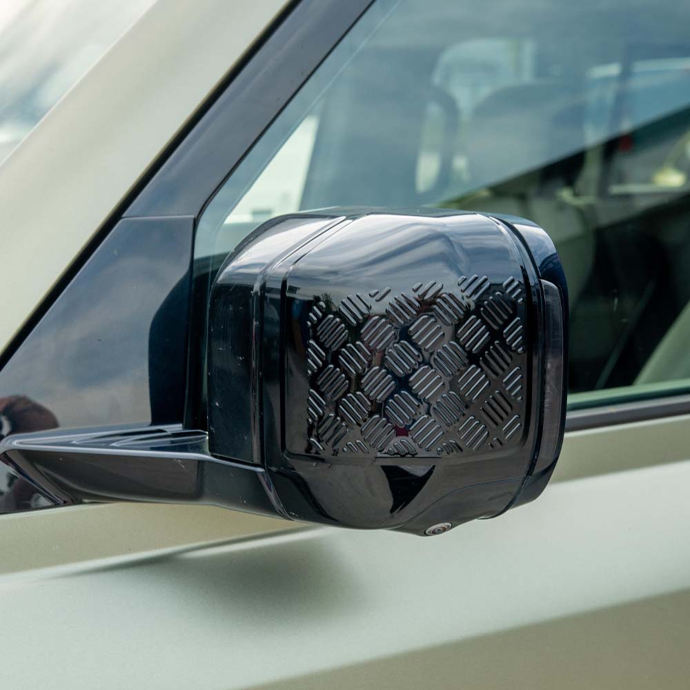 Gloss black anti-scratch trim set for Land Rover Defender L663 110 by CT Carbon, shown on vehicle parts.