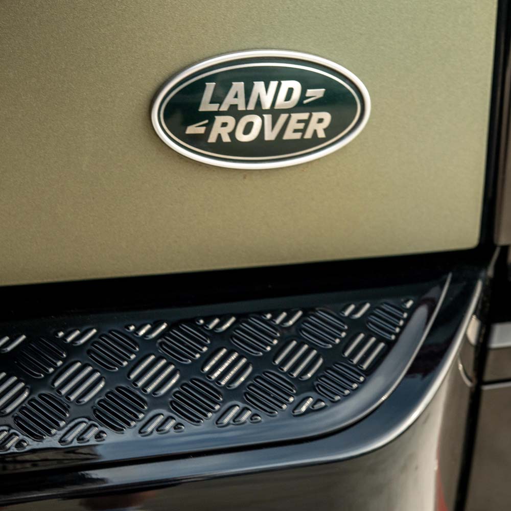 Gloss black anti-scratch trim set for Land Rover Defender L663 110 by CT Carbon, shown installed on vehicle body panels.