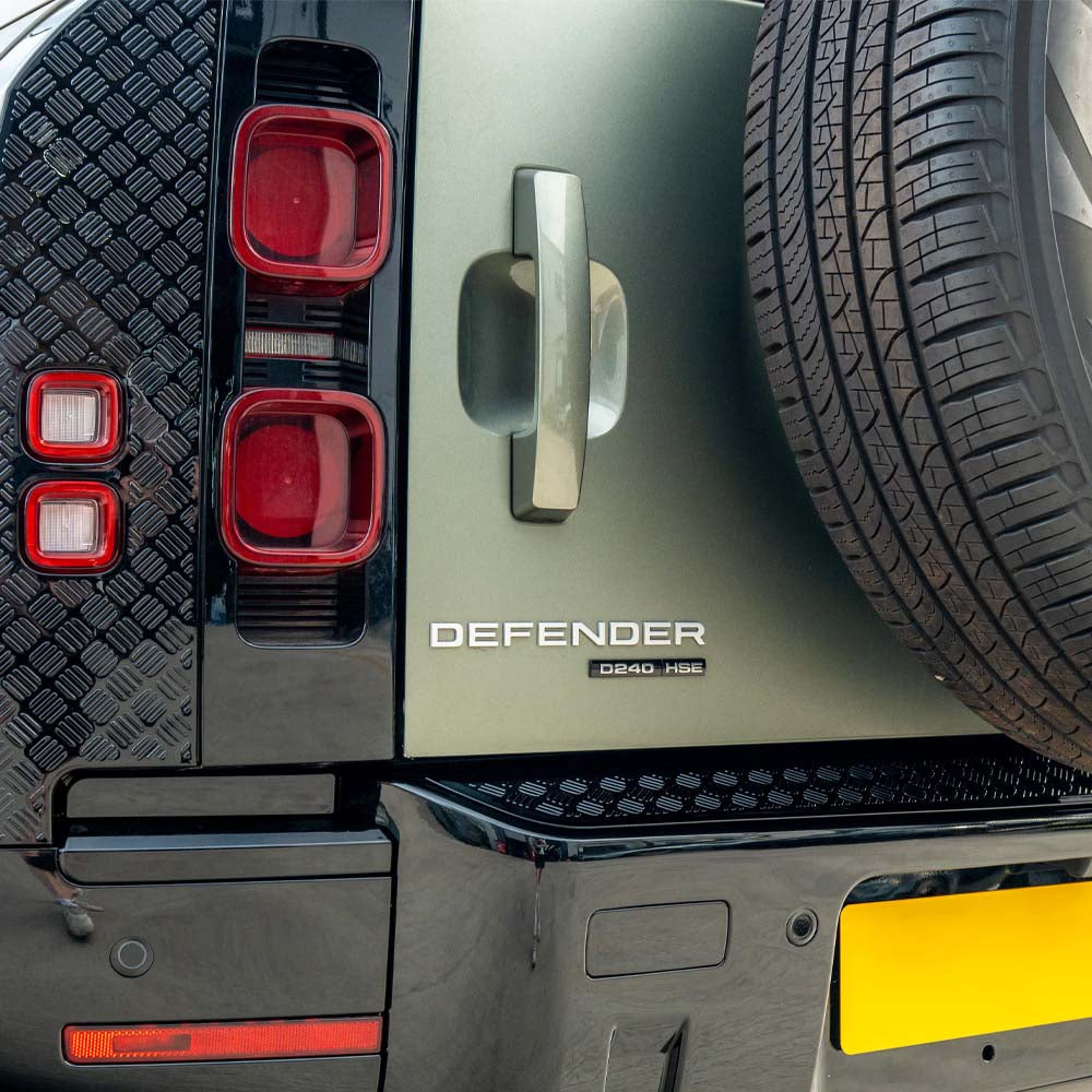 Land Rover Defender L663 110 gloss black anti-scratch trim set by CT Carbon, shown on vehicle exterior with sleek black finish.
